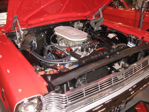 1968 Shelby GT500 - The engine bay of a 1968 Shelby GT500 is displayed, a prominent chrome air cleaner and vibrant red paint.