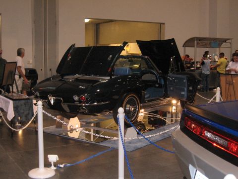 1968 Shelby GT500 - A 1965 Chevrolet Corvette Sting Ray convertible is displayed with its hoods and doors open at a car show.
