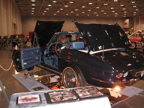 1968 Shelby GT500 - A classic dark blue convertible is displayed with its hood and doors open, revealing its interior and engine bay.