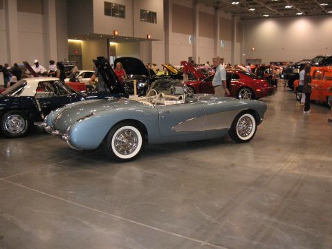 1968 Shelby GT500 - A light blue convertible is displayed at an indoor car show with other vehicles around.