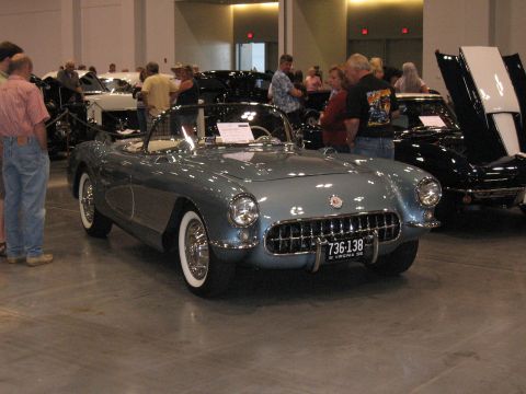 1968 Shelby GT500 - A light blue 1956 Chevrolet Corvette convertible is displayed indoors with other vehicles.
