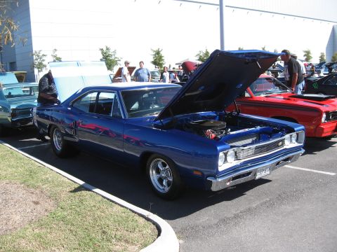 1968 Shelby GT500 - A blue 1968 Dodge Coronet is displayed with its hood open at an outdoor car event.