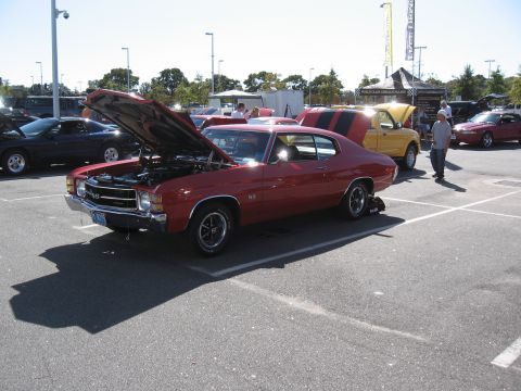 1968 Shelby GT500 - A red 1970 Chevrolet Chevelle SS is displayed with its hood open at an outdoor car event.