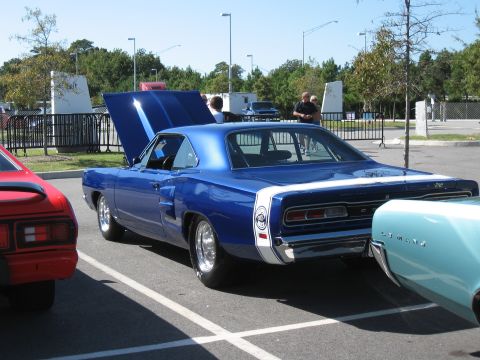 1968 Shelby GT500 - A blue 1968 Dodge Coronet is parked at an outdoor car show, with its hood up and other vehicles nearby.