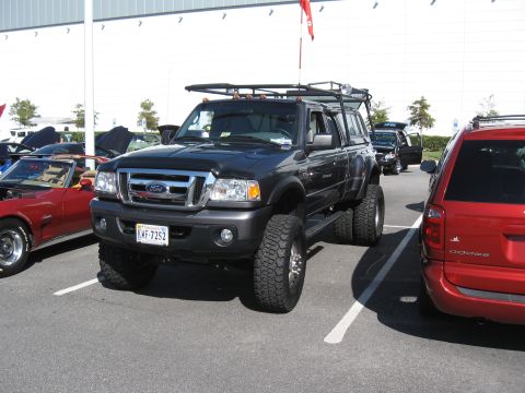 1968 Shelby GT500 - Modified Ford Ranger pickup truck with dual rear wheels parked at an outdoor event.