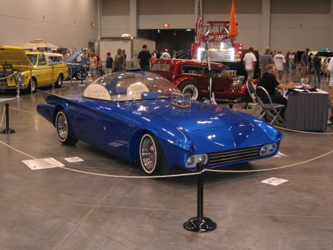 1968 Shelby GT500 - A unique blue custom car with a clear bubble top and distinctive fins is displayed indoors.