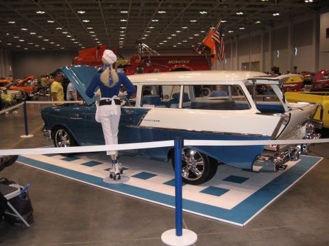 1968 Shelby GT500 - A vintage station wagon is displayed indoors with a mannequin dressed as a waitress standing beside it.