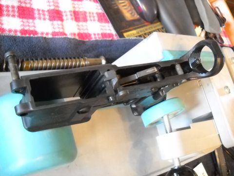 1996 Ford F-250 - Close-up of a gun receiver assembly being worked on, with tools and a checkered cloth in the background.