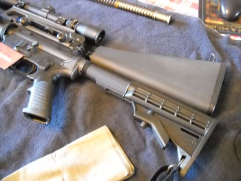 1996 Ford F-250 - An assault rifle with a scope is shown from an angled perspective on a blue cloth.