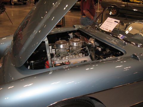 1968 Shelby GT500 - The engine bay of a light blue classic car is visible, dual carburetors and a sign indicating it is a 1966 model.