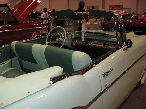 1968 Shelby GT500 - Interior view of a classic convertible, with another car visible in the background at a car show.