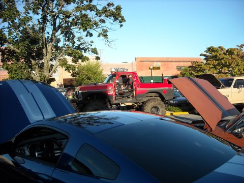 1979 Ford F-150 - A red 1979 Ford F-150 is parked at an outdoor car show with other vehicles.