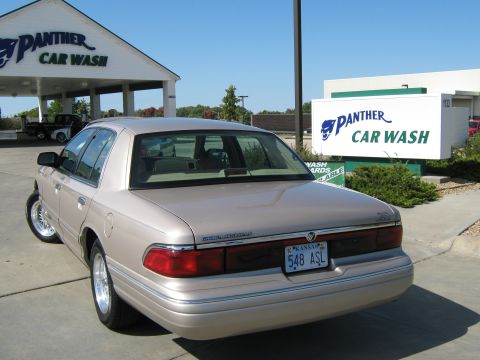 2000 Mercury Grand Marquis - A tan Mercury Grand Marquis is seen from the rear at a Panther Car Wash.