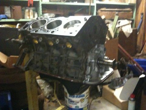 1993 Toyota 4Runner - Engine block on a stand, likely undergoing rebuild or repair in a garage setting.