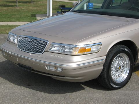 2000 Mercury Grand Marquis - The front end of a tan Mercury Grand Marquis is shown, its distinctive grille and headlights.
