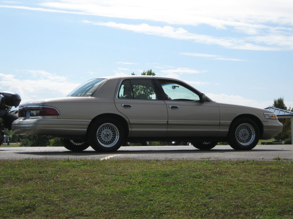 Tan 2000 Mercury Grand Marquis sedan, side view