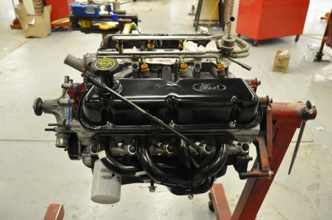 1996 Ford Bronco - Ford V8 engine on an engine stand, showing valve covers and exhaust headers.