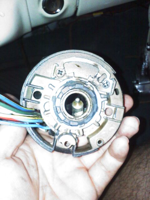 1977 Ford F-100 - Close-up of a steering column ignition switch housing with wiring harness.