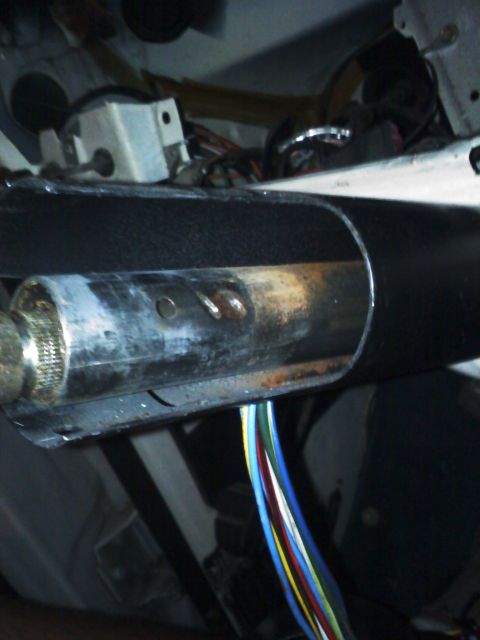 1977 Ford F-100 - Wiring bundle visible beneath the steering column, with various colored wires leading into the vehicle's systems.