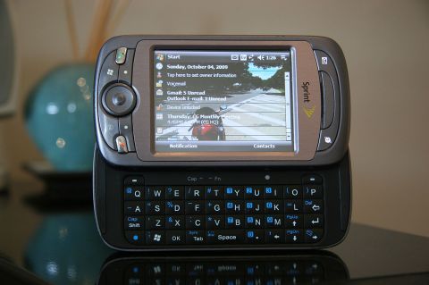 1992 Ford Taurus - This Sprint mobile phone features a slide-out QWERTY keyboard and a touchscreen interface.
