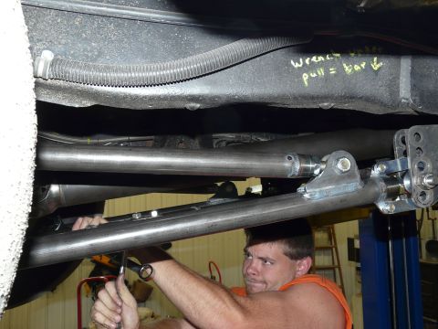 1994 Ford F-150 - Close underbody shot of a truck on a two-post lift, showing bare-steel four-link bars with threaded adjusters and rod ends bolted into weld…
