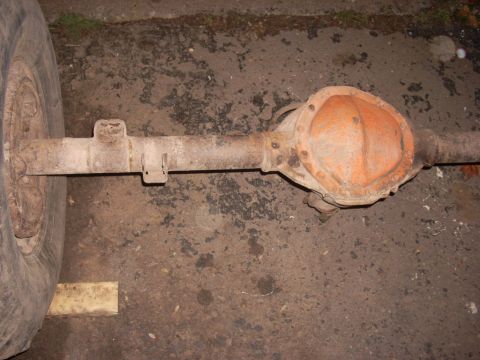 1988 Chevrolet Blazer - Rear axle assembly with a wheel attached, showing a rusty differential cover.