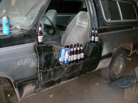 1988 Chevrolet Blazer - Custom door panels in a black Chevrolet K5 Blazer hold numerous beer bottles and cans.