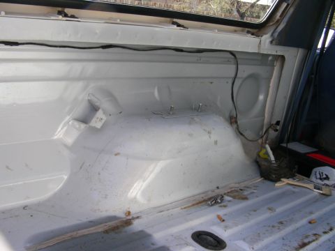 1996 Ford Bronco - The rear cargo area of the vehicle is visible, with some tools and debris on the floor.