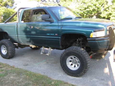 1998 Dodge 1500 - This lifted 1998 Dodge 1500 pickup truck is shown from the front three-quarter angle.