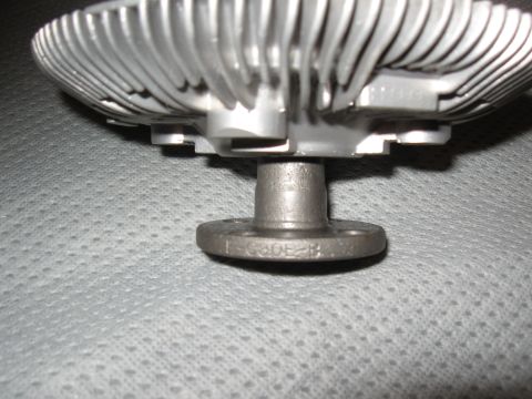 1968 Shelby GT500 - Close-up of a metal fan clutch, showing its ribbed design and a stamped part number on the flange.