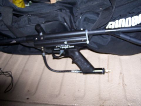 1986 Ford Bronco - A paintball gun is shown with a black bag in the background and a Supermotors.net watermark at the bottom.