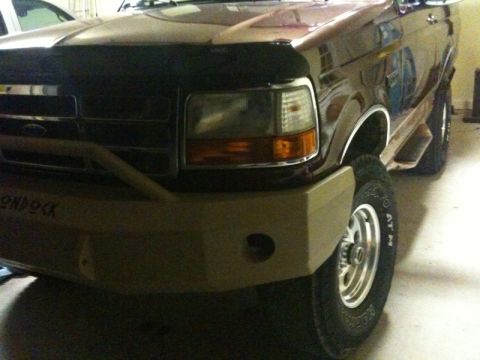 1996 Ford Bronco - This Ford truck features a custom bumper with visible text. The vehicle's body style suggests a mid-1990s model.