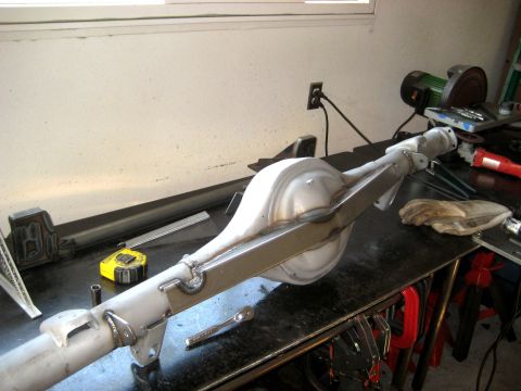 1996 Ford Bronco - A fabricated rear axle assembly sits on a workbench, ready for installation.