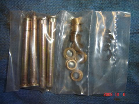 1993 Ford Bronco - A bagged kit contains door hinge pins, bushings, and clips, likely for a vehicle repair.