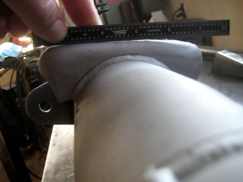 1996 Ford Bronco - A ruler measures a metal bracket attached to a pipe, suggesting a custom fabrication or repair.