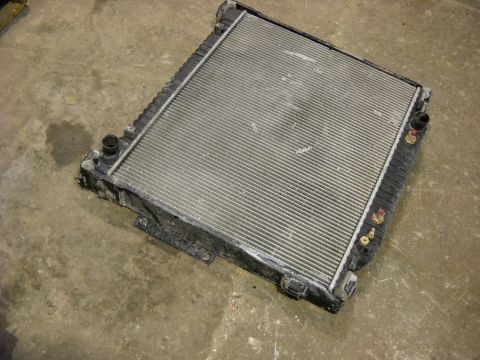 1986 Ford C-350 (Centurion Conversions) - A vehicle radiator is shown from a top-down perspective on a concrete surface.