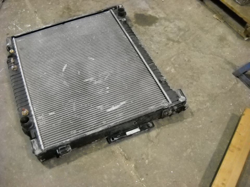 Radiator with black plastic end tanks and metal fins