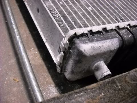 1986 Ford C-350 (Centurion Conversions) - Radiator damage is visible, including bent fins and corrosion on the tanks.