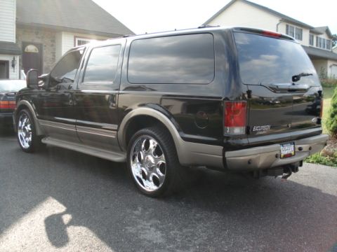 2000 Ford Excursion - Rear view of a black 2000 Ford Excursion Limited with chrome wheels.