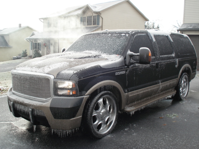 Black Ford Excursion with ice and icicles, 3q-front view