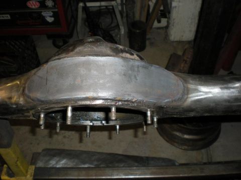 2009 Suzuki Samurai - Close-up view of a front axle differential housing, likely undergoing maintenance or modification.