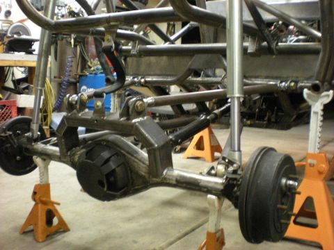 Suzuki Samurai - Garage shot of a linked solid axle mocked up under a bare tube chassis on orange jack stands, with a heavily trussed and gusseted housing,…