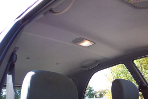 2001 Ford Crown Victoria - Interior view of a car's headliner and seats, with a dome light illuminated.