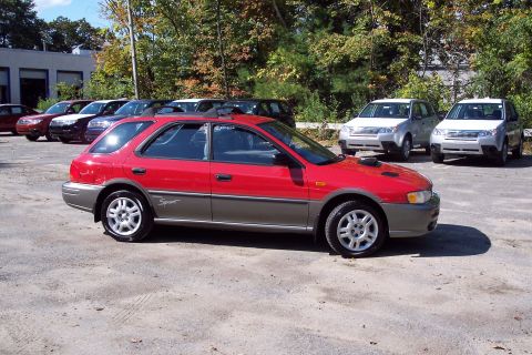 2001 Ford Crown Victoria - Red and gray 1998 Subaru Impreza Outback Sport wagon in a parking lot.
