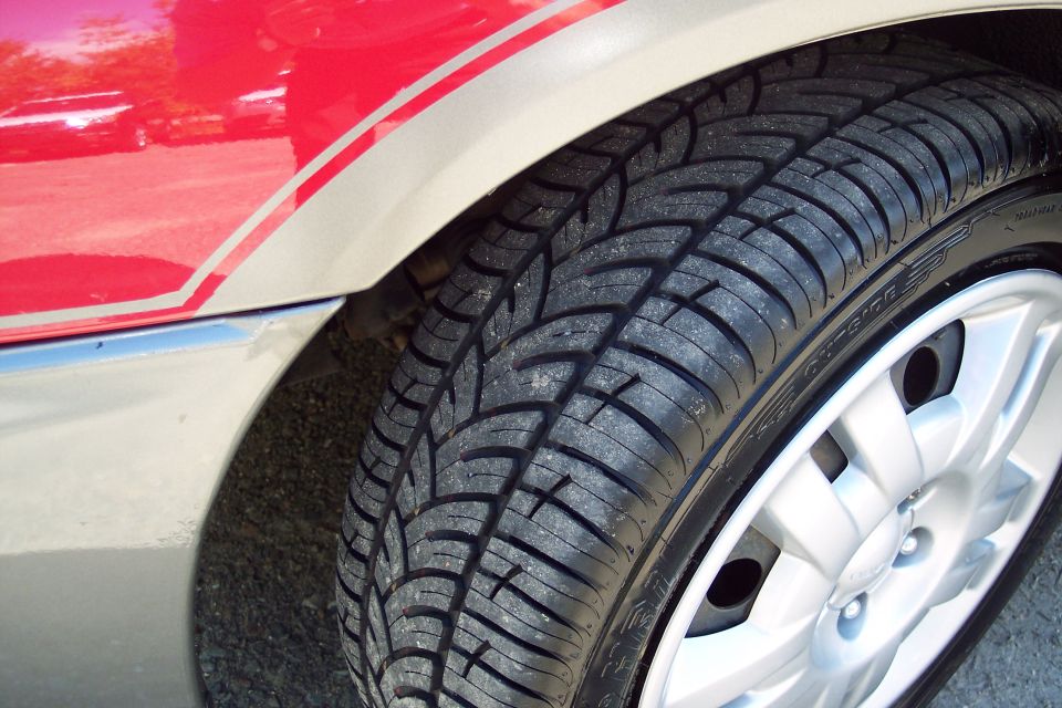 Red and tan two-tone fender with a tire and silver wheel