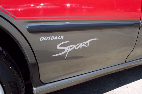 2001 Ford Crown Victoria - Car door shows 'OUTBACK Sport' decal and a red stripe detail.