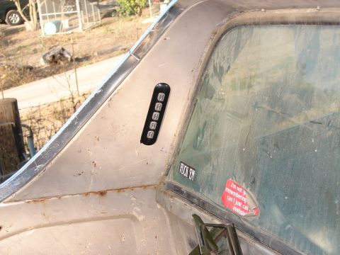1973 Ford Ranchero - A keypad and stickers adorn the side of a vehicle, with a red sticker reading 'I'm not so remembering, can I just call asshole?'