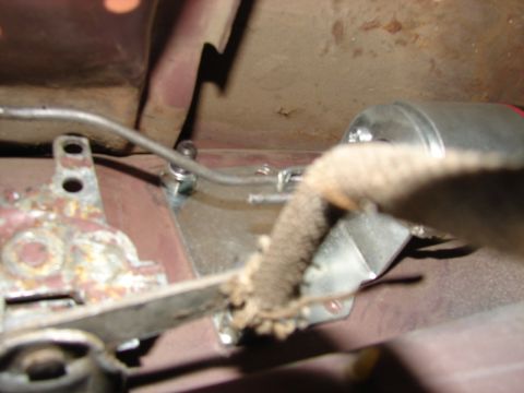 1973 Ford Ranchero - A detailed view of a metal bracket and cable assembly, likely a component from a vehicle's mechanical system.