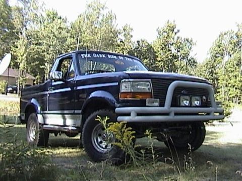 1995 Ford Bronco - This 1995 Ford Bronco is seen from a 3q-front angle, a brush guard and off-road lights.