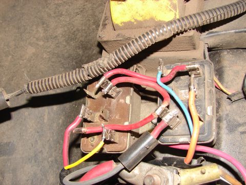 1973 Ford Ranchero - Detail of an automotive electrical relay, showing wiring connections and a yellow battery terminal cover.